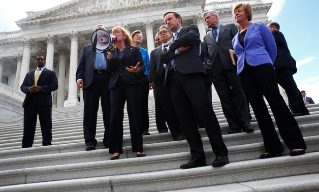 Senate Democrats gather on the Senate steps with protesters on Capitol Hill in Washington - REUTERS