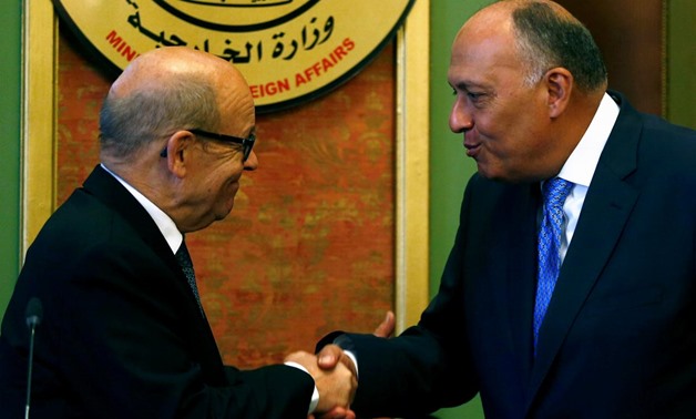 French Foreign Minister Jean-Yves Le Drian shakes hands with Egyptian Foreign Minister Sameh Shoukry (R) after their joint news conference in Cairo, Egypt June 8, 2017.

