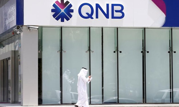 A man walks past a branch of Qatar National Bank (QNB) in Riyadh - Reuters