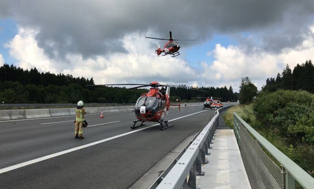 Helicopters at the site where a coach burst into flames after colliding with a lorry on a motorway near Muenchberg - REUTERS