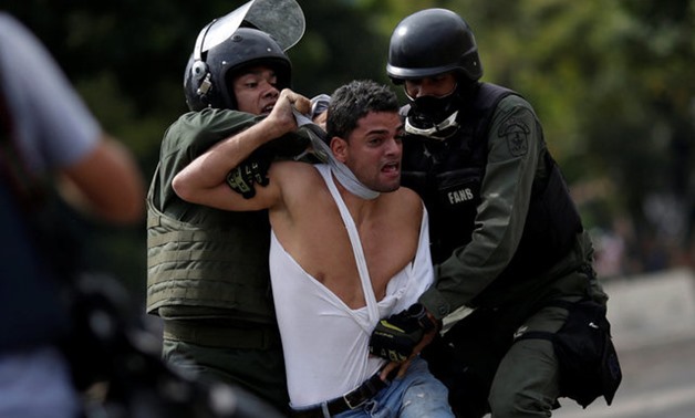 A demonstrator is detained at a rally during a strike called to protest against Venezuelan President Maduro's government in Caracas - REUTERS