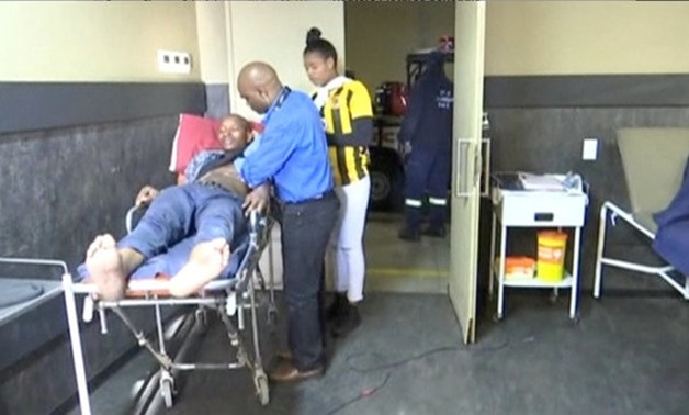 A man who was injured during a stampede at South Africa's FNB Stadium is attended to by paramedics in Soweto, Johannesburg, South Africa, in this still image from video taken July 29, 2017. SABC via Reuters TV/via REUTERS ATTENTION EDITORS - THIS IMAGE WA