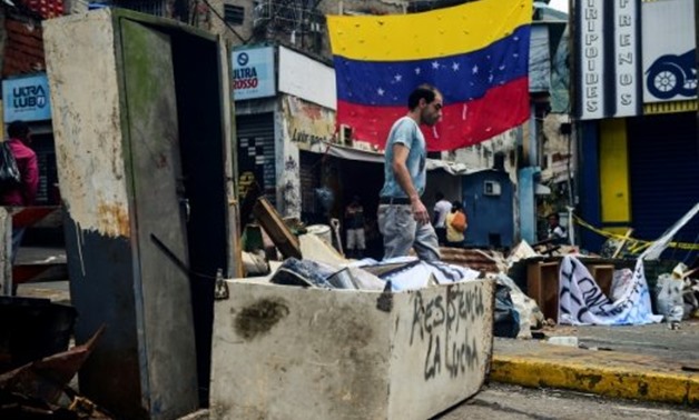 © AFP / by Maria Isabel SANCHEZ | View of a barricade set up by activists during a protest called by the opposition, in Caracas on July 29, 2017
