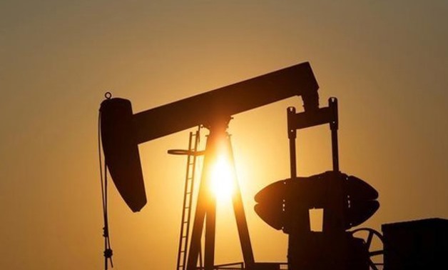 An oil pump jack pumps oil in a field near Calgary, Alberta, Canada 