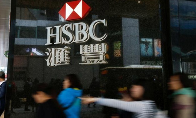 People walk past a major branch of HSBC at the financial Central district in Hong Kong - Reuters