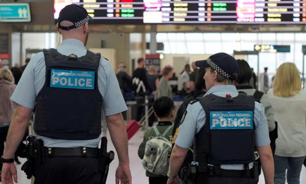 Australia Federal Police officers patrol the security lines at Sydney's Domestic Airport in Australia, July 31, 2017, following weekend raids related to a plot against Australia's aviation sector - Reuters