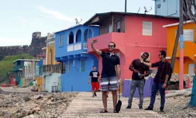 © AFP / by Leila MACOR | A man takes a selfie in the Puerto Rican neighbourhood of La Perla, where the video for the pop hit "Despacito" was filmed
