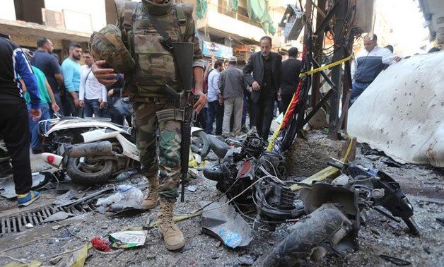 A Lebanese army soldier walks past damaged motorbikes at the site of the two explosions that occurred on Thursday in the southern suburbs of the Lebanese capital Beirut - Reuters