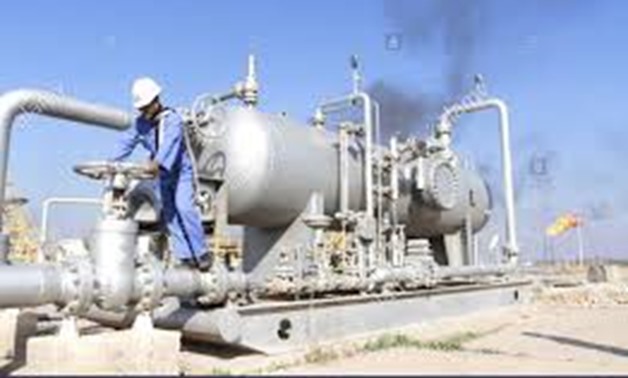 FILE PHOTO: A worker checks the valve of an oil pipe at Nahr Bin Umar oil field, north of Basra, Iraq December 21, 2015.
