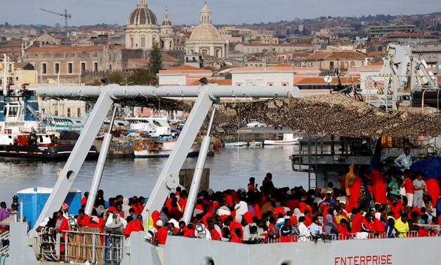 Migrants wait to disembark from Royal Navy Ship HMS Enterprise in the Sicilian harbor of Catania, Italy, October 23, 2016 - REUTERS/Antonio Parrinello/File Photo