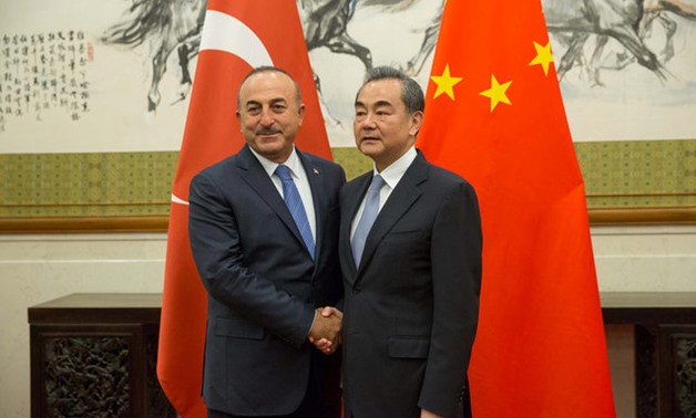 Chinese Foreign Minister Wang Yi (R) shakes hands with Turkish Foreign Minister Mevlut Cavusoglu during their meeting at Diaoyutai State Guesthouse in Beijing, China, 03 August 2017. REUTERS
