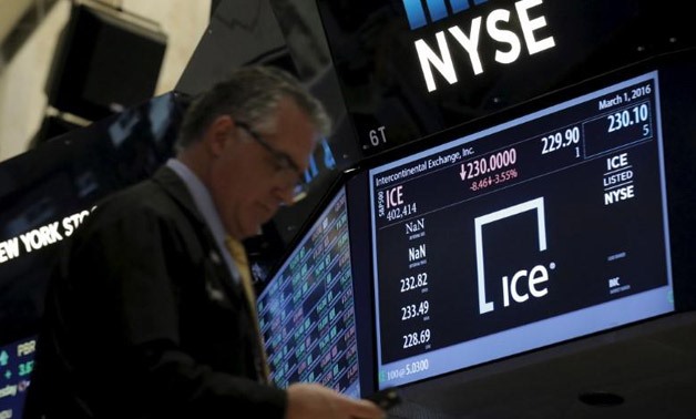 A trader passes by a screen that displays the trading info for Intercontinental Exchange Inc. (ICE) on the floor of the New York Stock Exchange (NYSE) March 1, 2016.
Brendan McDermid
