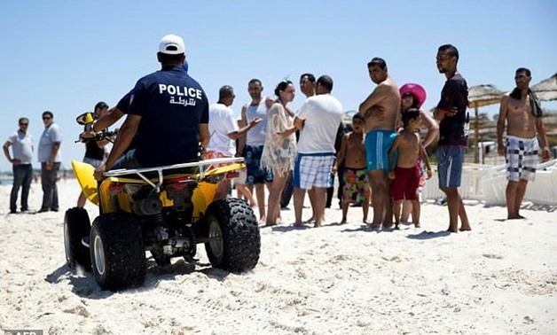 Tunisian police patrol the beach in front of the Riu Imperial Marhaba Hotel near in Tunisia on June 27, 2015, a day after a gunman shot and killed 38 tourists, most of them British holidaymakers in an attack claimed by the jihadists Islamic State group


