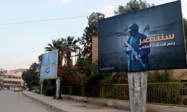 Islamic State billboards line a street in Raqqa, eastern Syria- Reuters