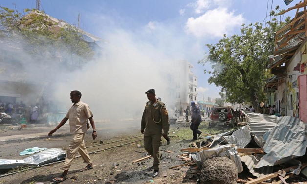 A local security guard walks past the scene after an explosion outside Darishifa hospital in Mogadishu, Somalia August 4, 2017.
