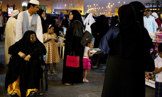 In this photo, Qatari women shop at Souq Waqif in Doha, Qatar. A number of Qatari women are aiming to raise awareness with a campaign called “Reflect Your Respect" that promotes modest clothing in the country. (AP Photo/Razan Alzayani)


