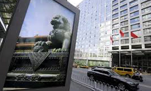 FILE PHOTO: An advertising board (L) showing a Chinese stone lion is pictured near an entrance to the headquarters (R) of China Securities Regulatory Commission (CSRC), in Beijing, China September 7, 2015.
Jason Lee