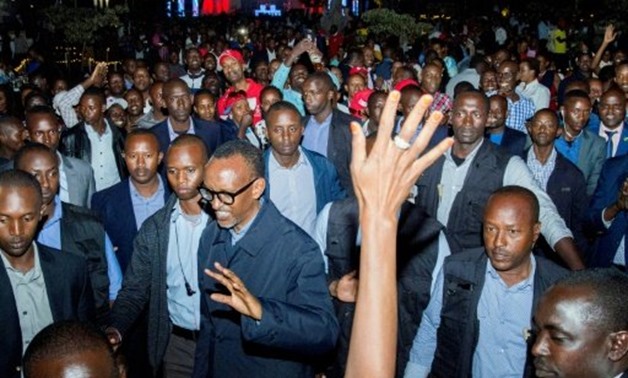 © AFP / by Stephanie AGLIETTI | Rwandan President Paul Kagame (C) celebrated his reelection with supporters in Kigali on Saturday
