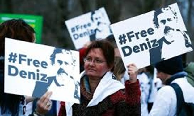 FILE PHOTO - Protestors carry placards during a demonstration to support arrested German-Turkish journalist Deniz Yucel outside theTurkish Embassy in Berlin, Germany, February 28, 2017.
