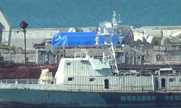 FILE PHOTO: A still image taken from video footage shows blue tarpaulins covering equipment at the port of Feodosia, Crimea July 11, 2017.
Staff/File Photo