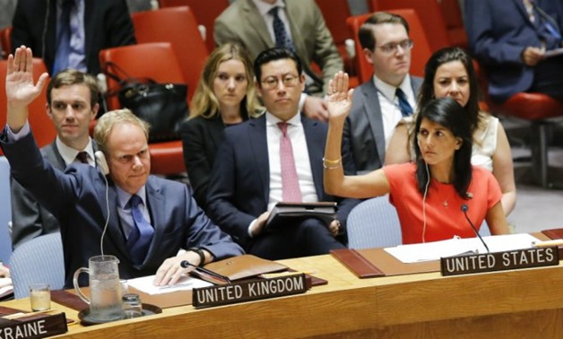 US Ambassador to the UN Nikki Haley (R) and Britain's Ambassador Matthew Rycroft vote on toughening sanctions on North Korea - AFP