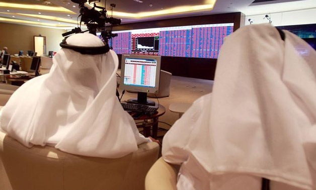 Traders monitor screens displaying stock information at Saudi Stock Exchange 