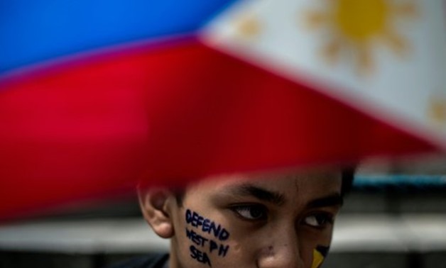 © AFP/File | Activists protest in Manila in June 2016 against China's island-building but the Philippine government is now softening its stance

