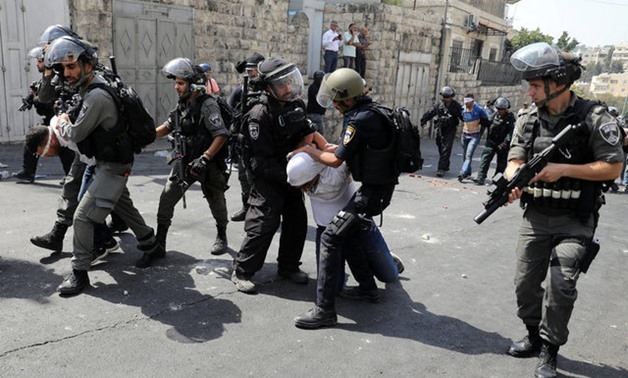 Israeli security forces arrest Palestinian men following clashes outside Jerusalem's Old city July 21, 2017. REUTERS/Ammar Awad