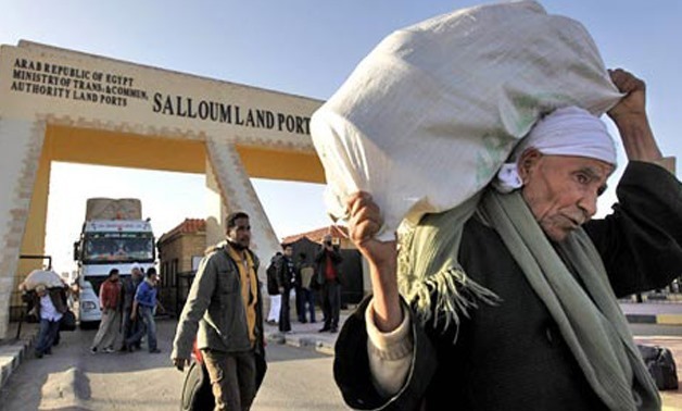 FILE - 212 Egyptians return home from Libya via Salloum crossing