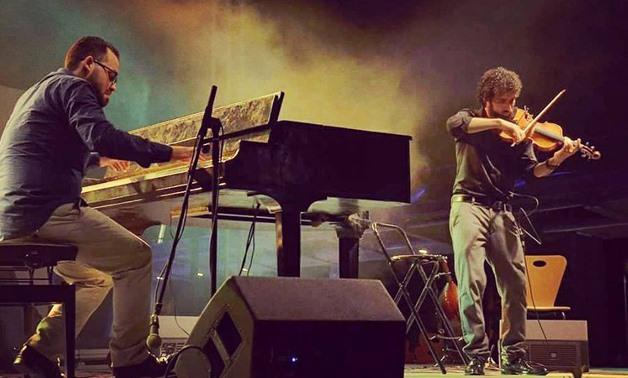 Foud and Mounib performing on one of their concerts (the official page of them)