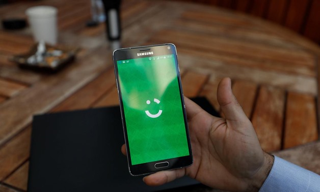 An employee shows the logo of ride-hailing company Careem on his mobile in his office in the West Bank city of Ramallah July 17, 2017.
Mohamad Torokman