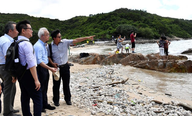 Under Secretary for the Environment Tse Chin-wan, visits a beach at Lamma Island on the progress of the cleaning up of palm oil by the govetnment, in Hong Kong, China August 8, 2017. REUTERS/Government Information Services/Handout via REUTERS NO RESALES. 