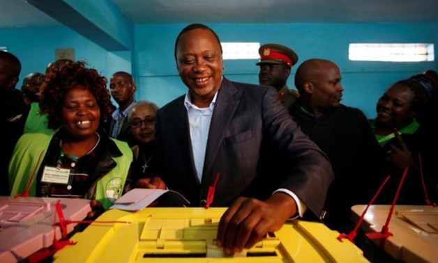 Kenya's President Uhuru Kenyatta casts his ballot inside a polling station in his hometown of Gatundu in Kiambu county - Reuters