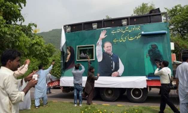 Pakistani supporters of deposed prime minister Nawaz Sharif gather around a container prepared for the rally led by Sharif in Islamabad - AFP