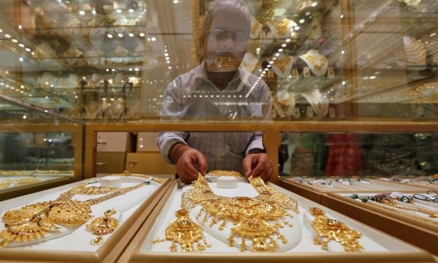 A salesman arranges a gold necklace in a display case inside a jewellery showroom in Kolkata on May 9, 2016.
Rupak De Chowdhuri