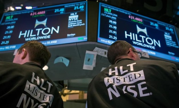 Traders wear special vests for the Hilton IPO on the floor of the New York Stock Exchange December 12, 2013 - REUTERS
