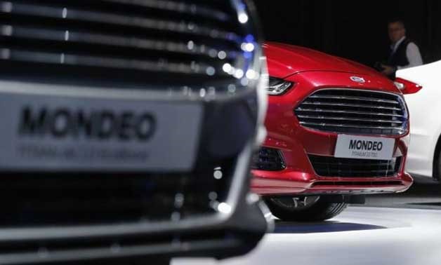 A visitor walks past new Ford Mondeo cars on display on media day at the Paris Mondial de l'Automobile, September 28, 2012.
Christian Hartmann