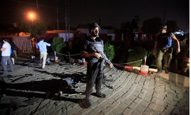 A policeman stands guard after a blast in Lahore - REUTERS