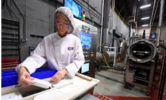Lea M Mohr, Director of Technical Services, prepares packages for the MATS-B machine as she makes packaged meals at an Ameriqual facility with new microwave technology that Amazon.com Inc is evaluating, in Evansville, Indiana, U.S. August 9, 2017- Reuters