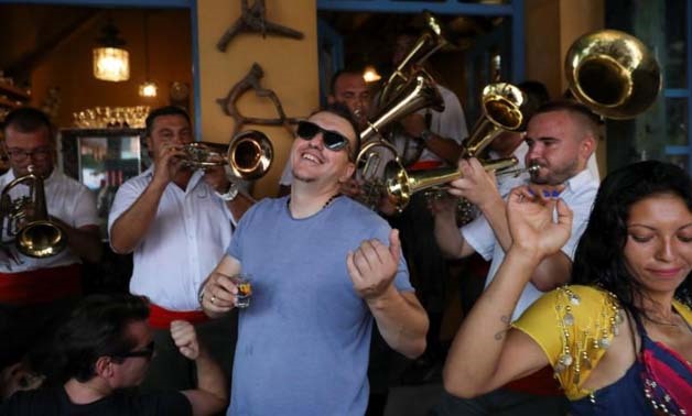 Revellers sing and dance as a band plays during the 57h Brass Band Festival, in the village of Guca, Serbia August 11, 2017. Picture taken August 11, 2017.
Marko Djurica