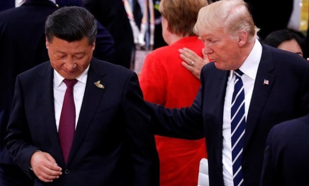 U.S. President Donald Trump talks to China's President Xi Jinping during the G20 leaders summit in Hamburg - Reuters