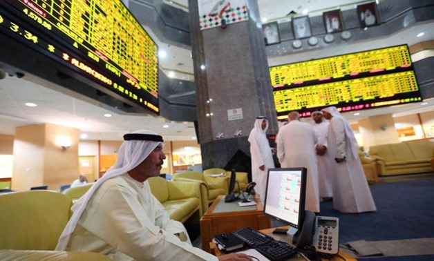 An investor monitors a screen displaying stock information at the Abu Dhabi Securities Exchange June 25 - Reuters