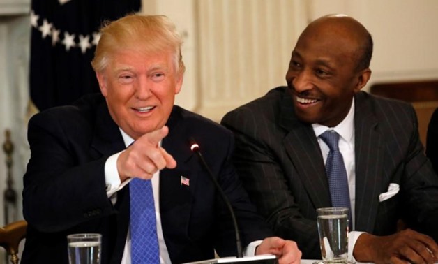 Merck & Co. CEO Ken Frazier (R) listens to President Donald Trump speak during a meeting with manufacturing CEOs at the White House - Reuters