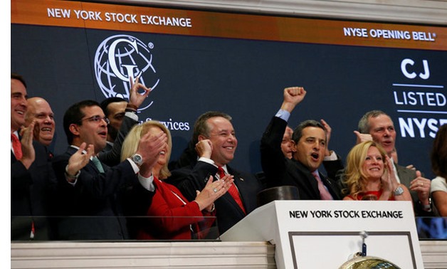 Executives and guests of C&J Energy Services Ltd. ring the opening bell at the NYSE to celebrate their re-listing following successful completion of Chapter 11 reorganization in New York - REUTERS