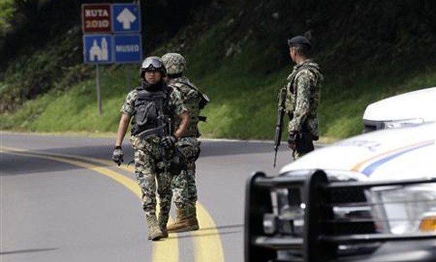 Mexican marines stand guard as U.S. officials and Mexican investigators take evidence from the scene where two CIA officers were shot on road near Tres Marias, outside Mexico City August 29, 2012- REUTERS