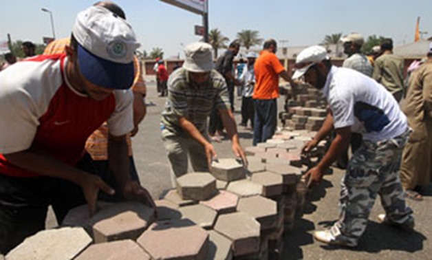 Protesters remove pavement tiles in Rabaa sit-in - File Photo