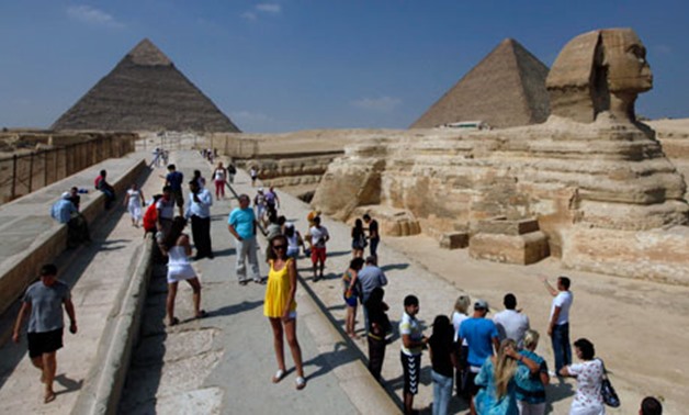 Tourists at the Sphinx and the Pyramids of Giza in Cairo - Reuters