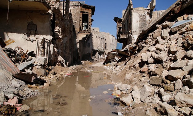 Mustafa al-Now is seen on debris in the old city of Aleppo - REUTERS