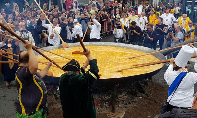 Members of the worldwide fraternity of the omelette prepare a traditional giant omelette made with 10,000 eggs in Malmedy, Belgium August 15, 2017 - Reuters