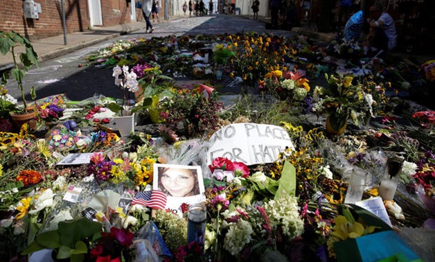 Flowers are pictured on the street where Heather Heyer was killed when a suspected white nationalist crashed his car into anti-racist demonstrators in Charlottesville - REUTERS